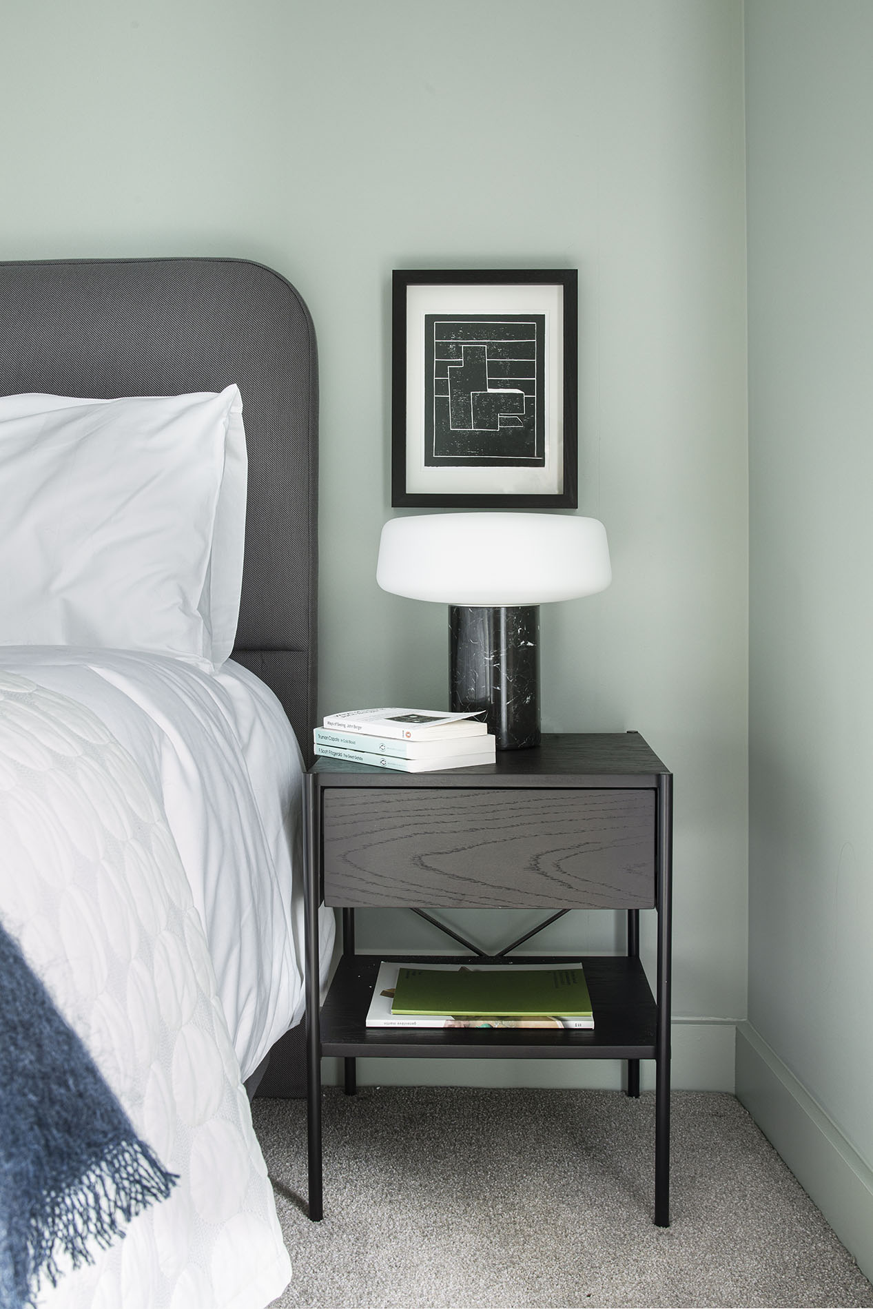 Bedside table with lamp and books Bedside table with lamp and books