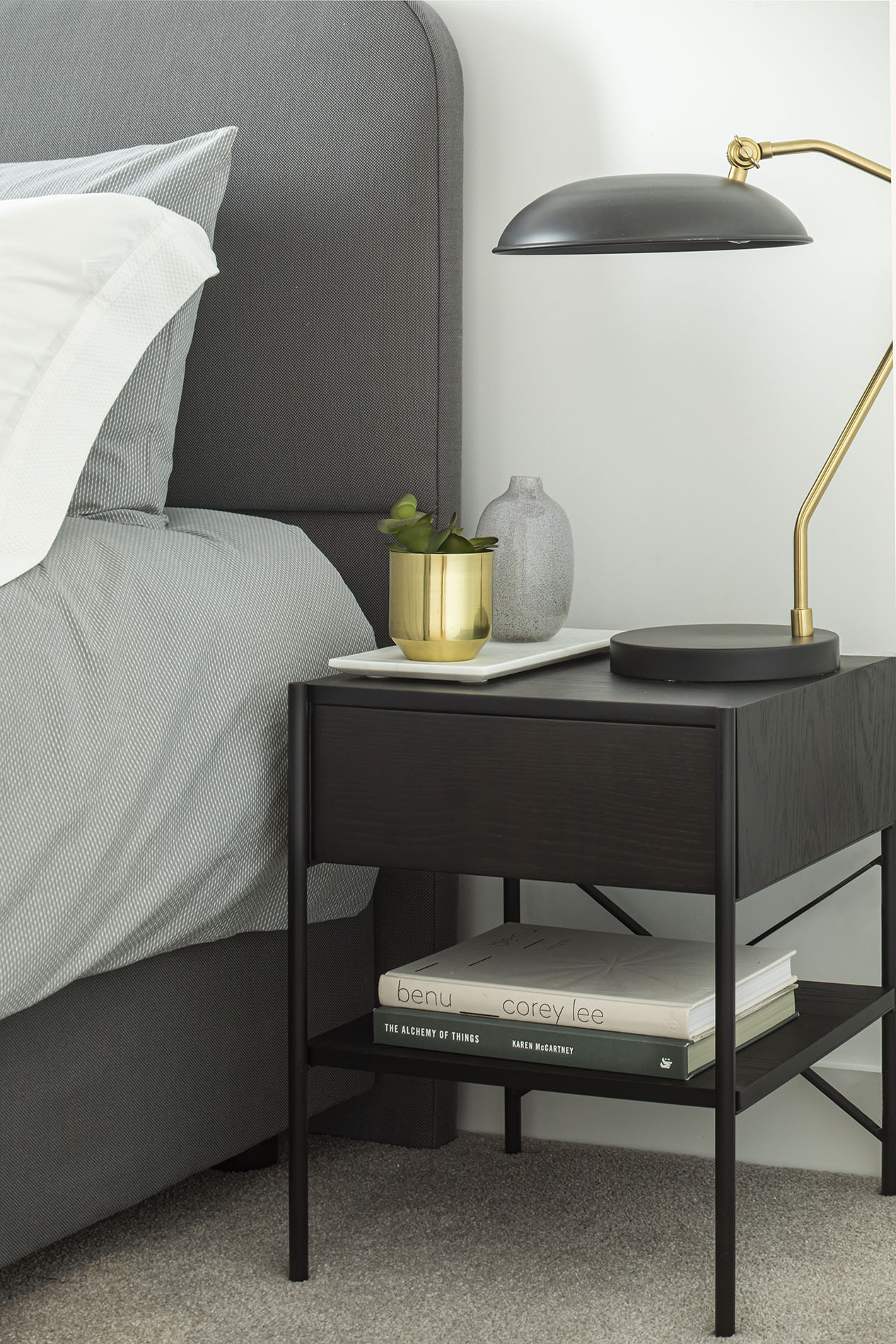 Bedside table with plant and books Bedside table with plant and books