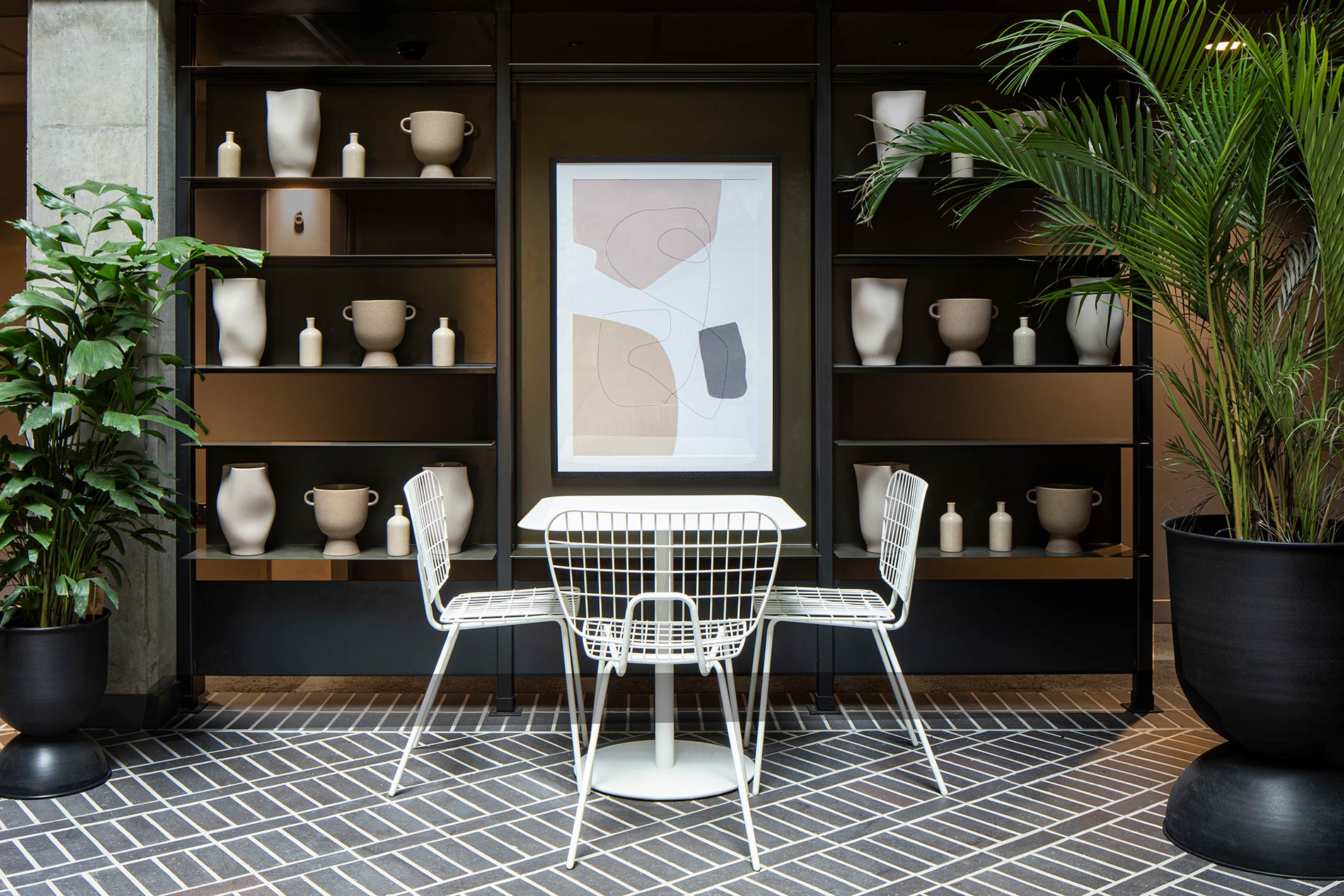 Table and chairs by artwork and shelves Table and chairs by artwork and shelves