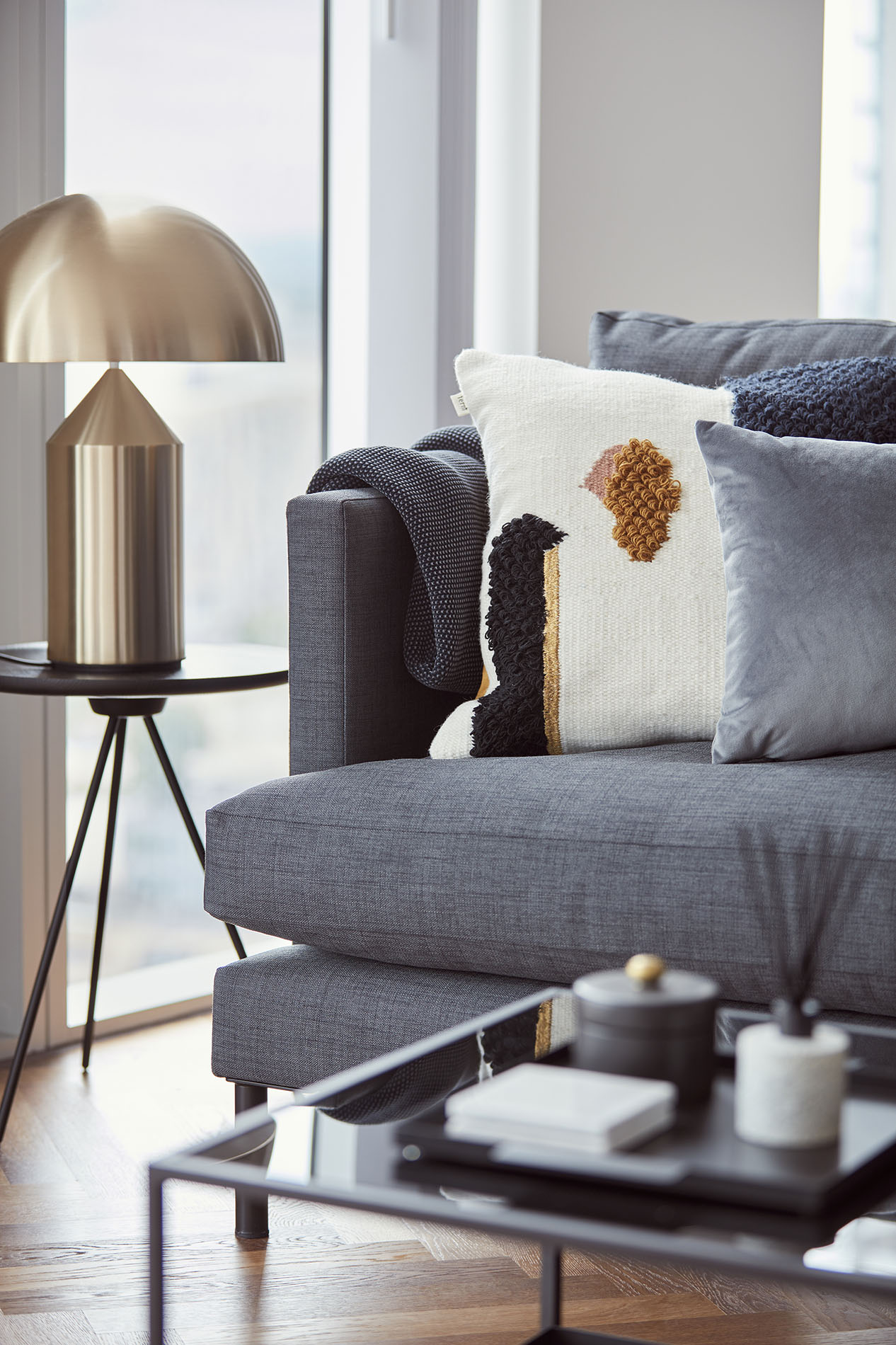 Sofa detail in living room with table and lamp Sofa detail in living room with table and lamp