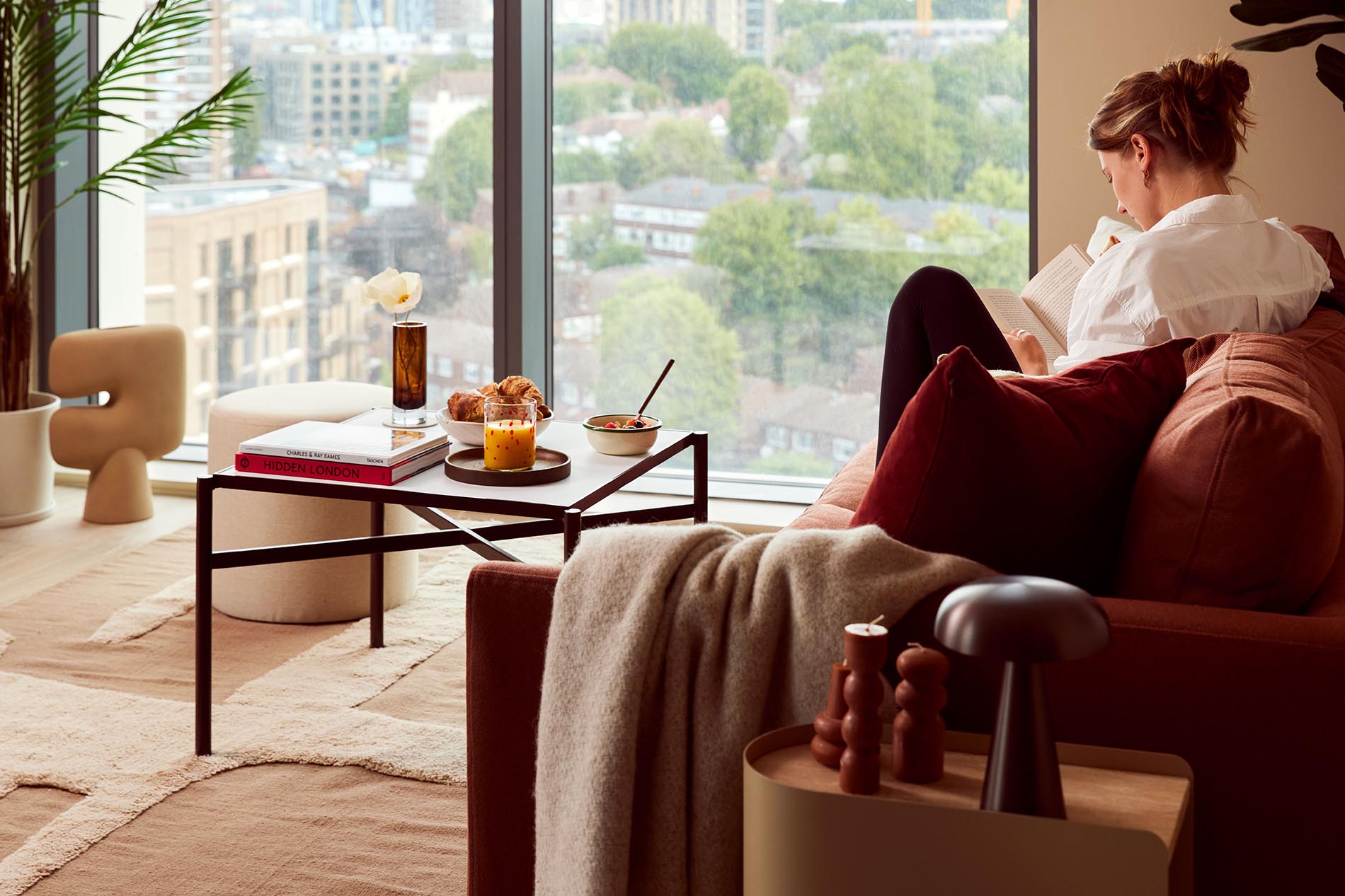 Reading Book on Sofa by Window Reading Book on Sofa by Window