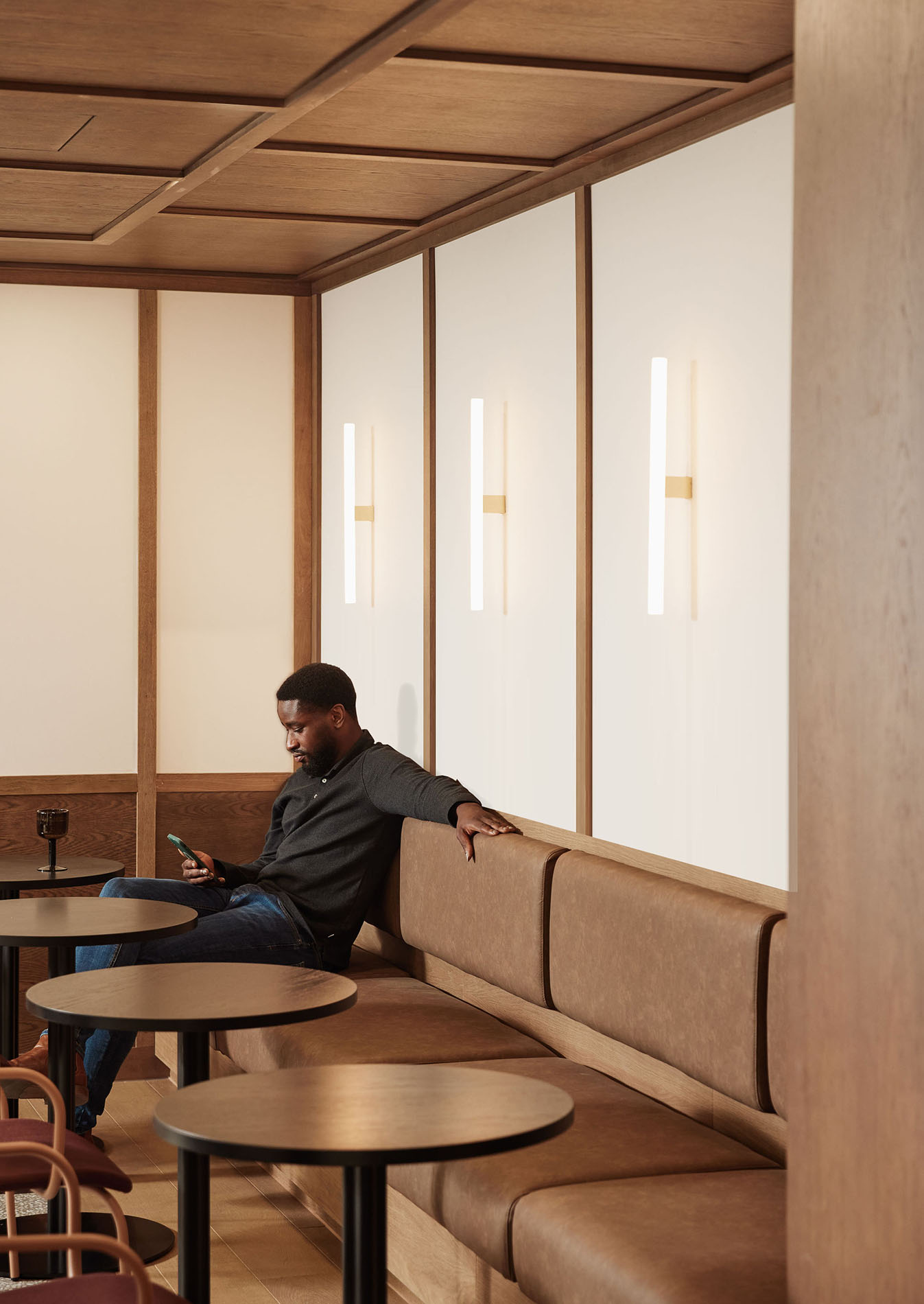 Man sitting with phone on sofa