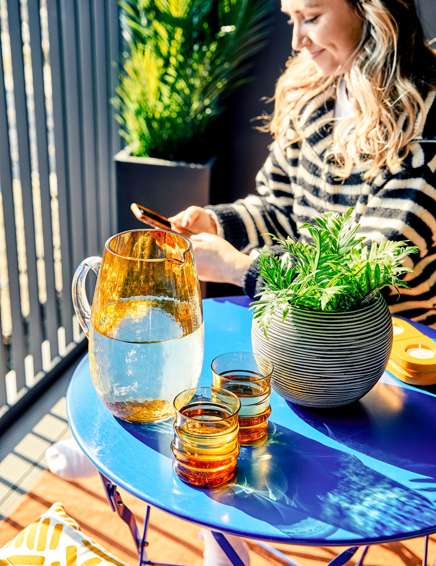 Lady using phone by coffee table